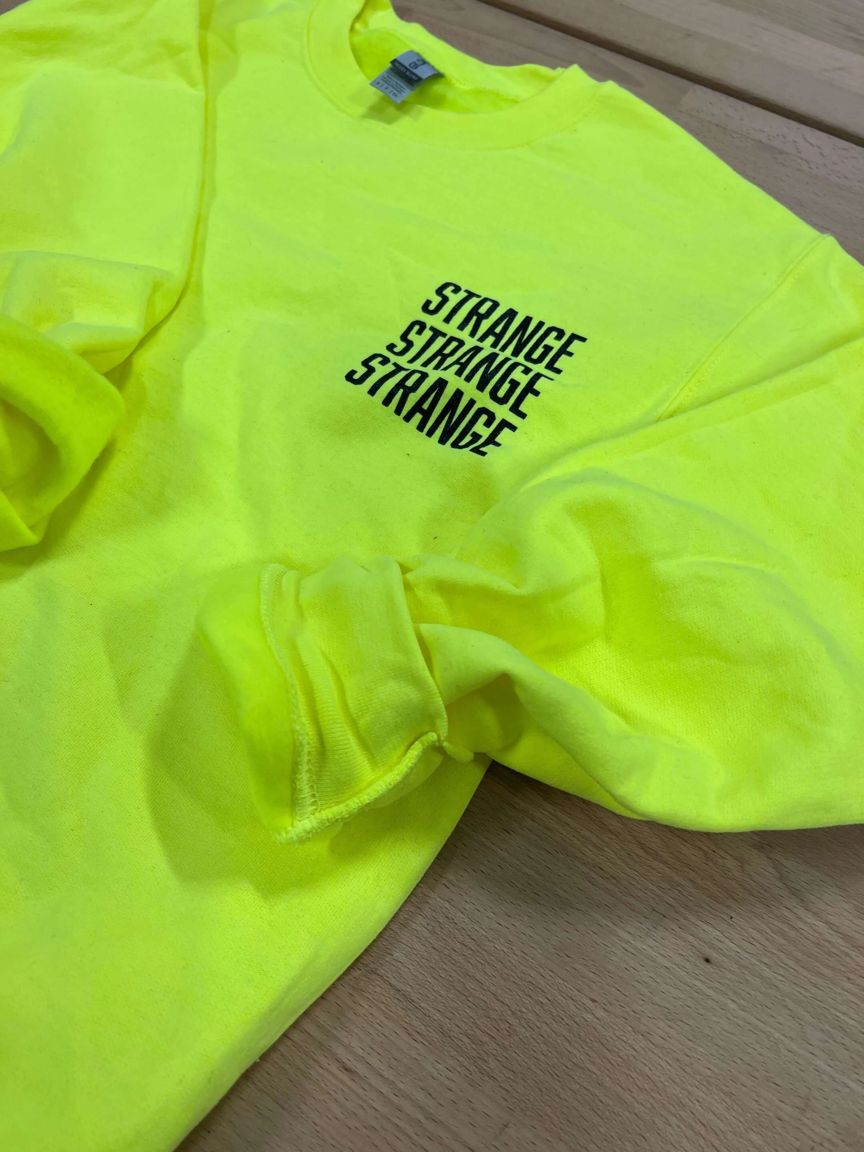 "Strange Strange Strange" small logo crewnecks